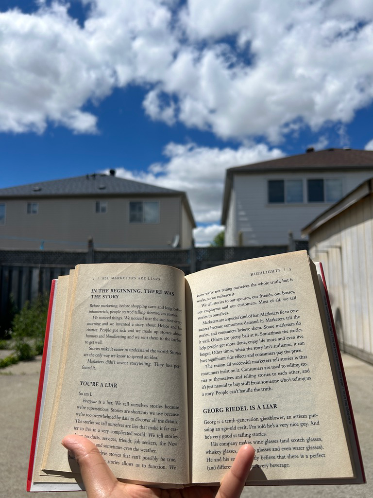 Reading a book under a blue sky